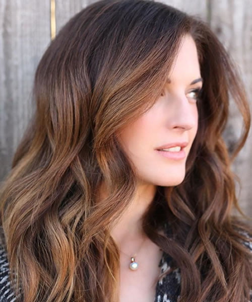 center parted brown hair with honey highlights